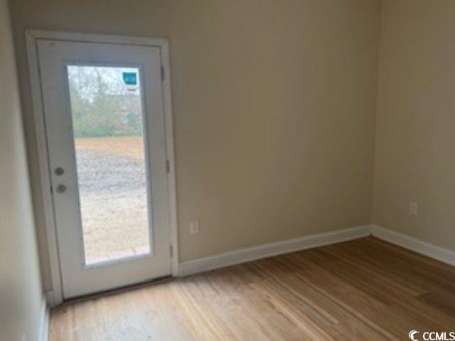 304 South Magnolia Avenue Andrews, SC 29510 - Photo 16 of 19 Entryway featuring wood finished floors and baseboards