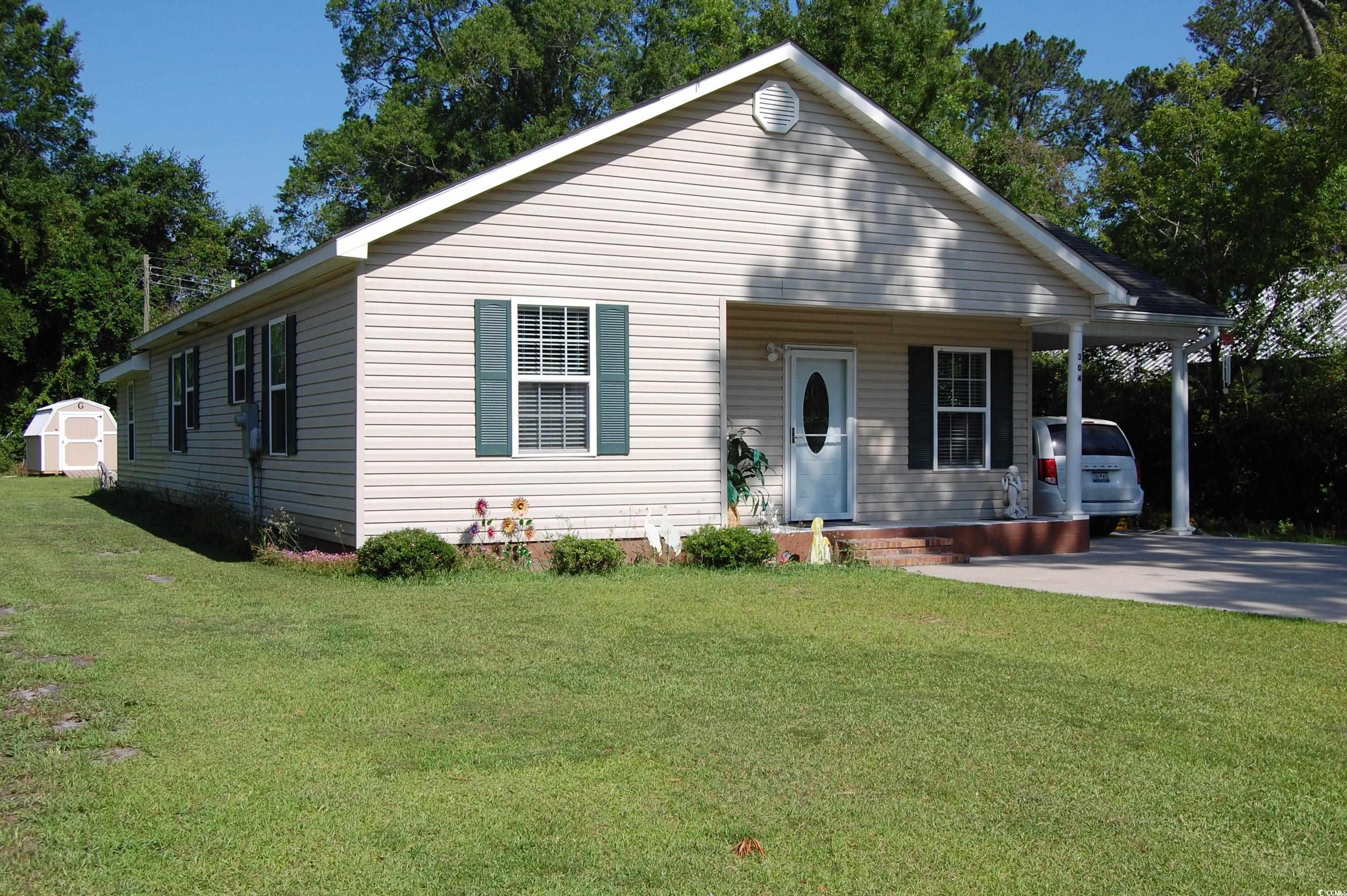 304 South Magnolia Avenue Andrews, SC 29510 - Photo 3 of 19 View of front of property with a front lawn