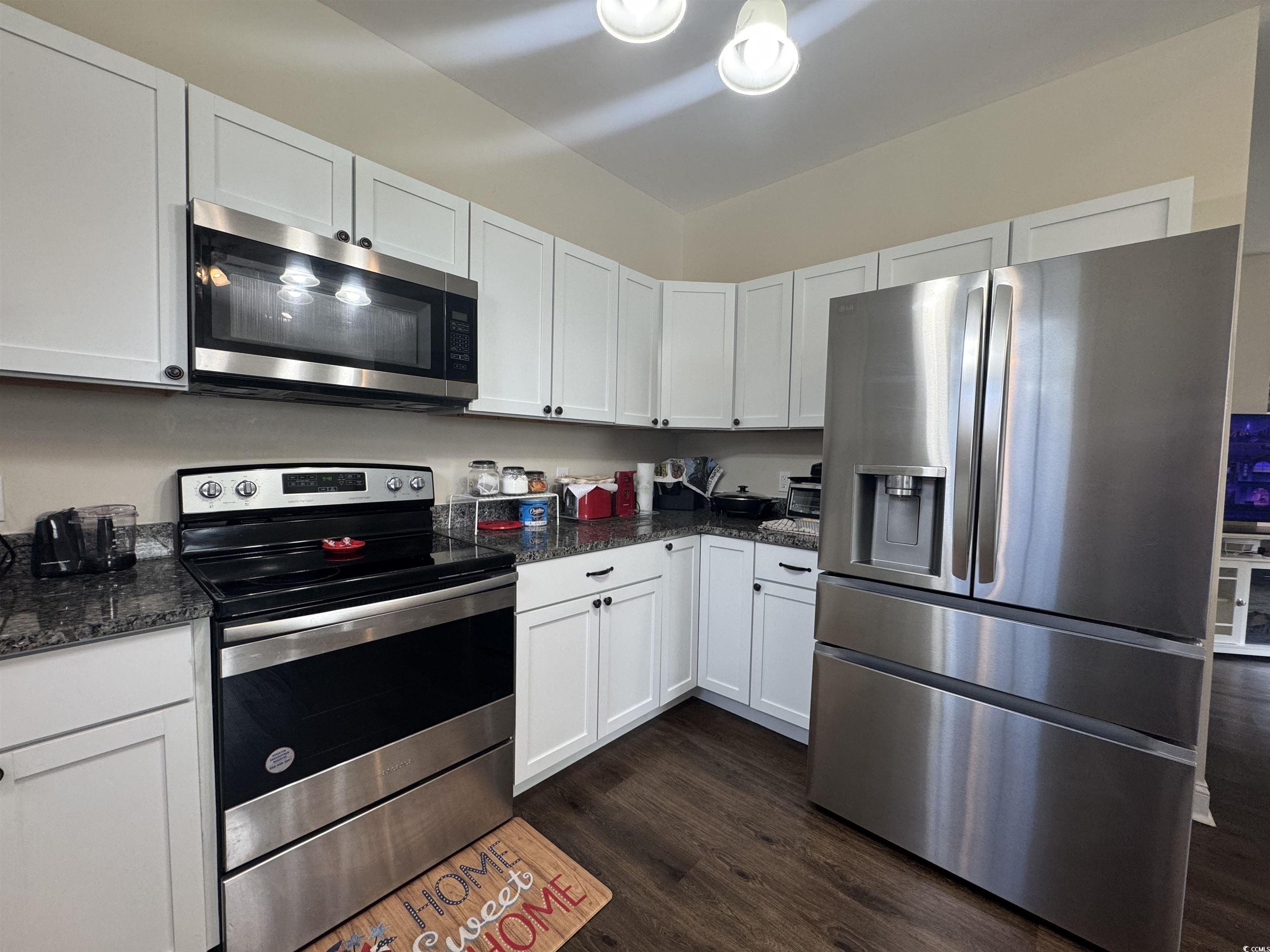 304 South Magnolia Avenue Andrews, SC 29510 - Photo 9 of 19 Kitchen featuring stainless steel appliances, dark wood finished floors, and white cabinets