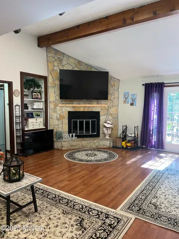 a living room with furniture a flat screen tv and a fireplace