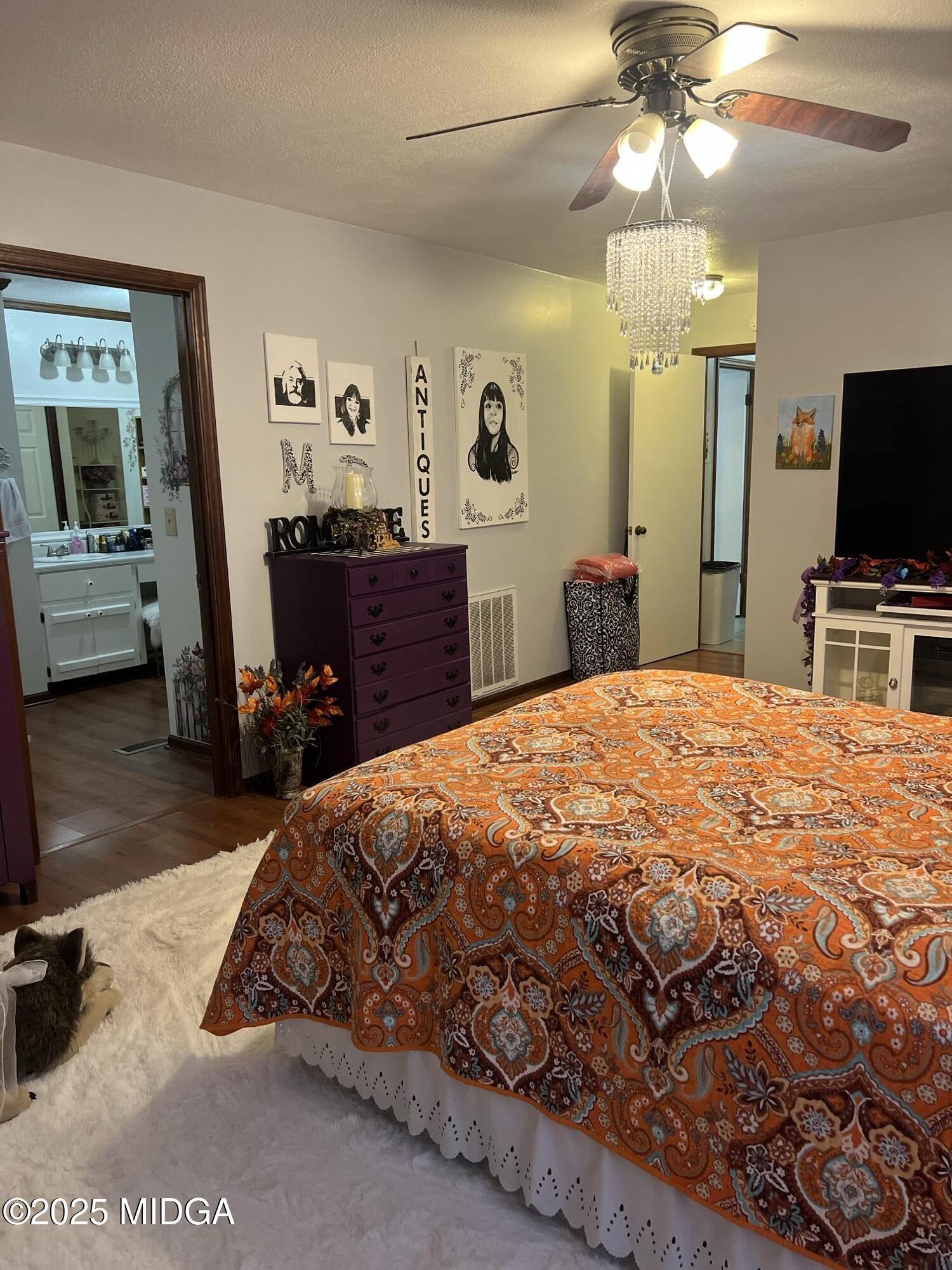 311 Overlook Drive Montezuma, GA 31063 - Photo 10 of 25 a bedroom with a bed and a flat tv screen on dresser