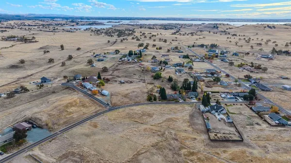 an aerial view of a parking space with wooden fence