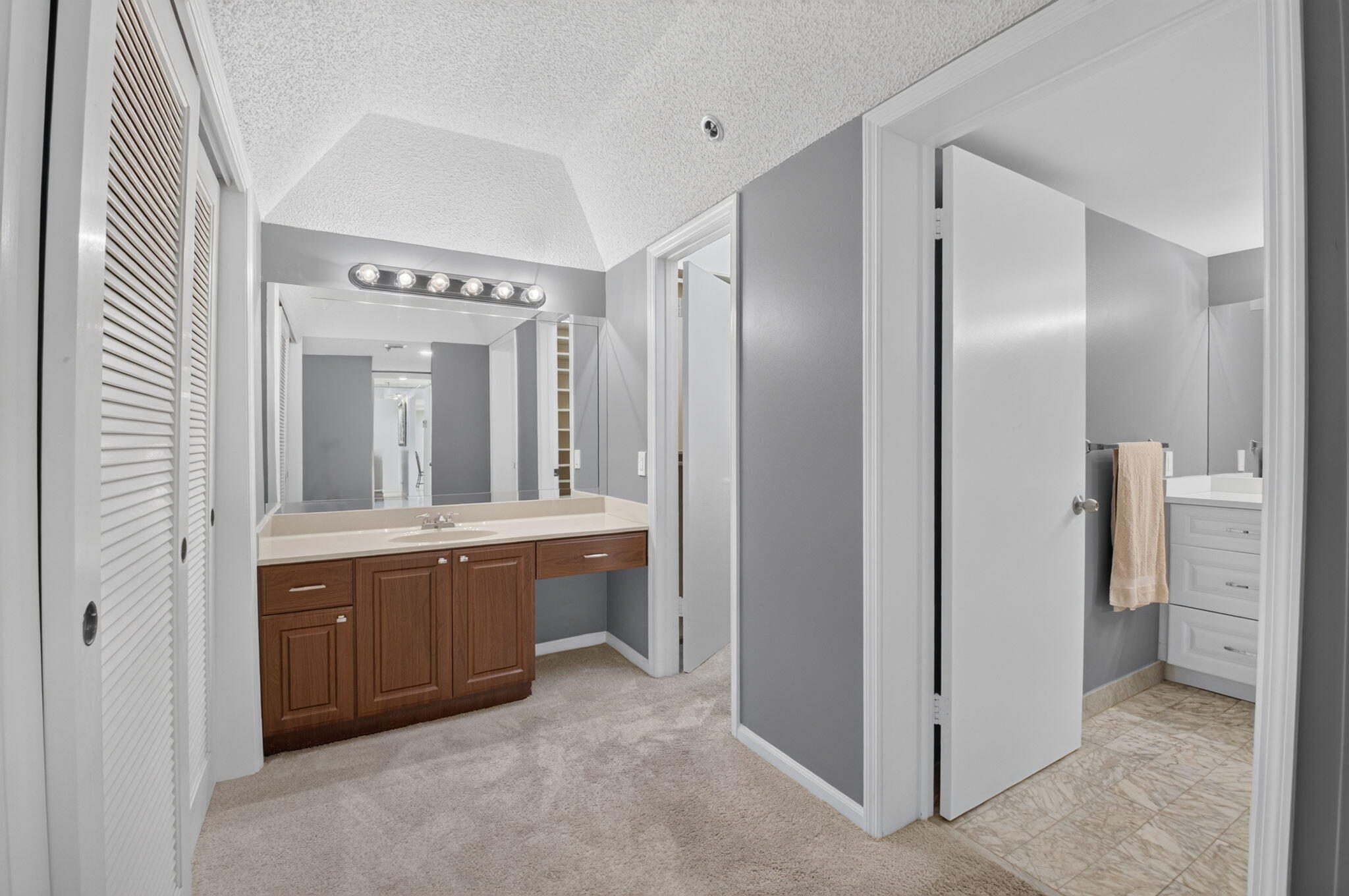1401 South Ocean Boulevard, Unit 1060 Boca Raton, FL 33432 - Photo 19 of 46 a spacious bathroom with a granite countertop sink and mirror