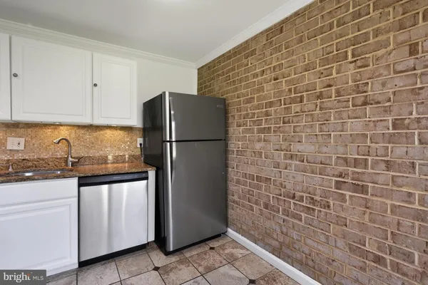 a kitchen with stainless steel appliances a refrigerator and a stove