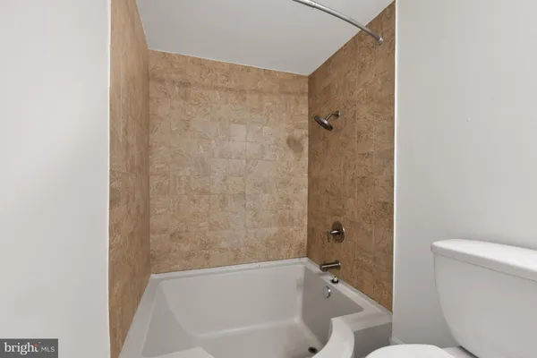 a bathroom with a toilet and a bathtub