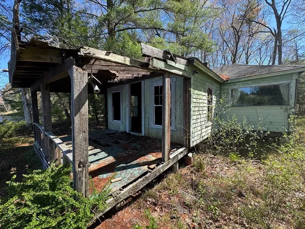 a view of a house with yard and sitting area