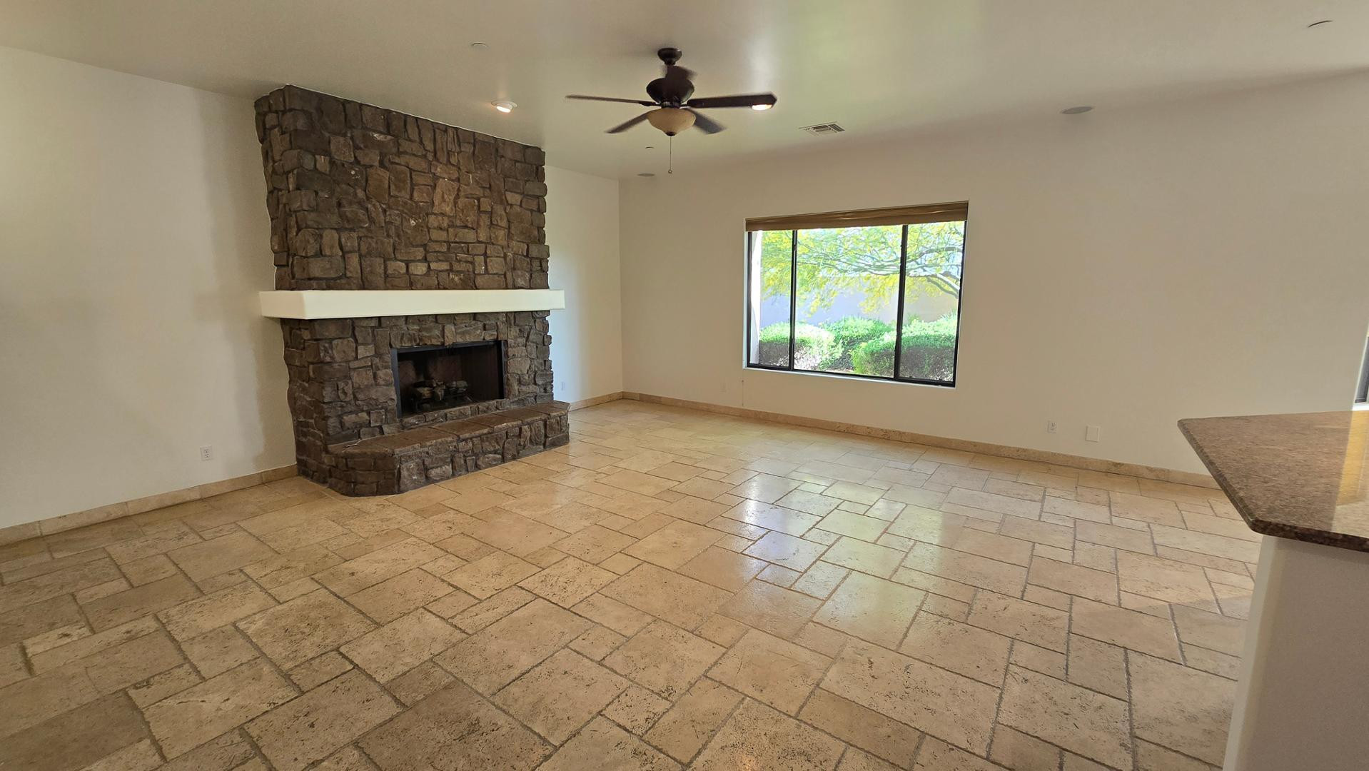4485 East Quail Brush Road Cave Creek, AZ 85331 - Photo 15 of 64 an empty room with windows and fireplace