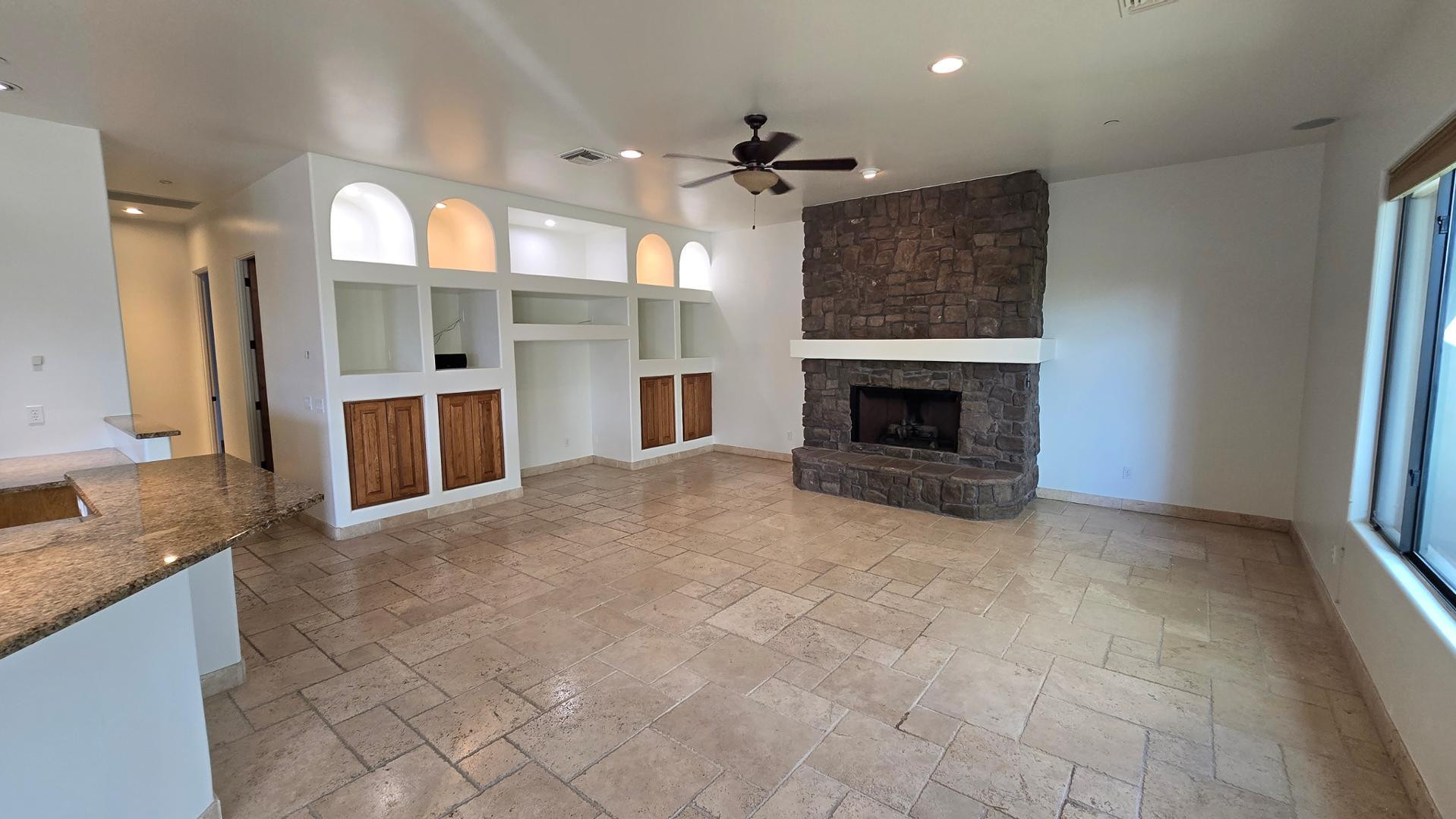 4485 East Quail Brush Road Cave Creek, AZ 85331 - Photo 19 of 64 a view of an empty room with a fireplace and a window