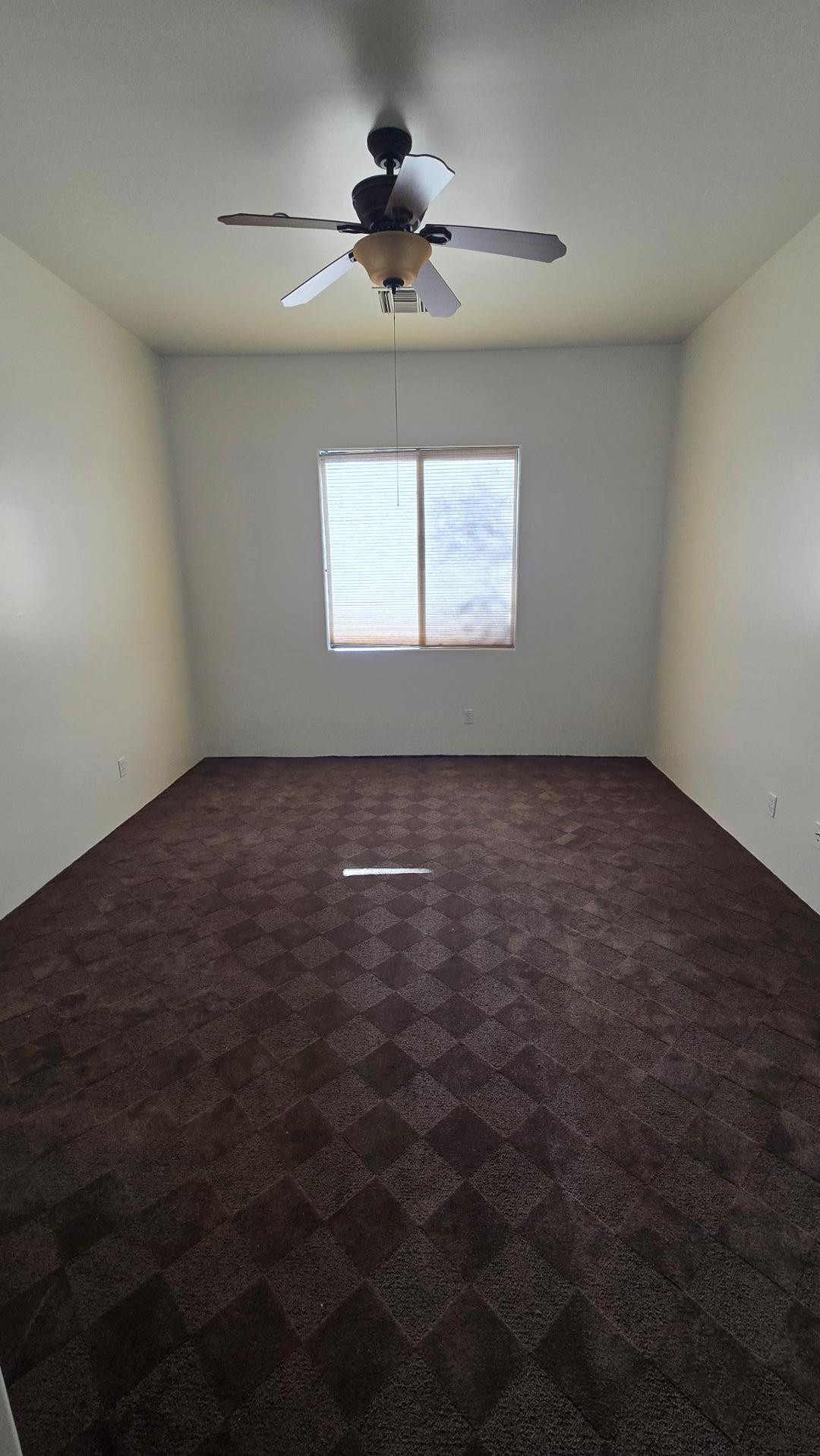 4485 East Quail Brush Road Cave Creek, AZ 85331 - Photo 40 of 64 an empty room with a window and a ceiling fan