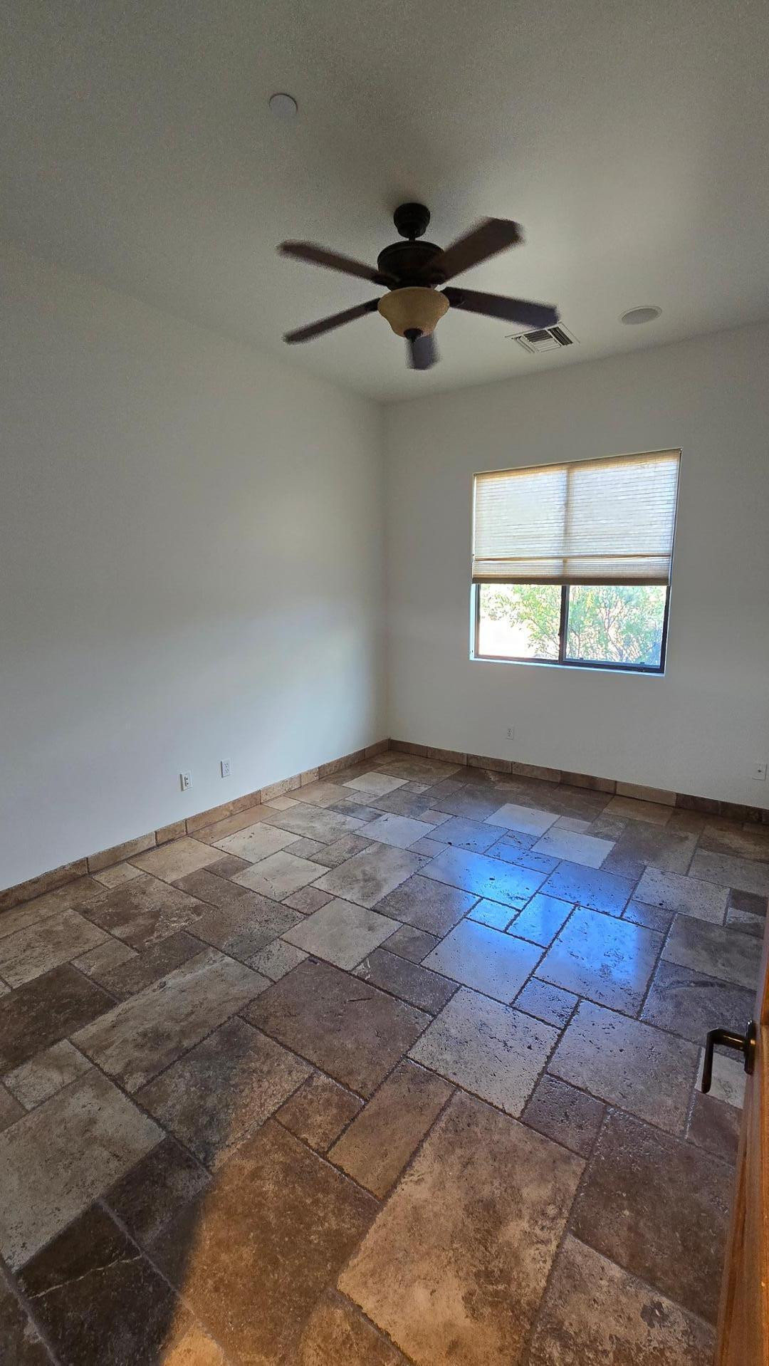 4485 East Quail Brush Road Cave Creek, AZ 85331 - Photo 10 of 64 an empty room with wooden floor and windows