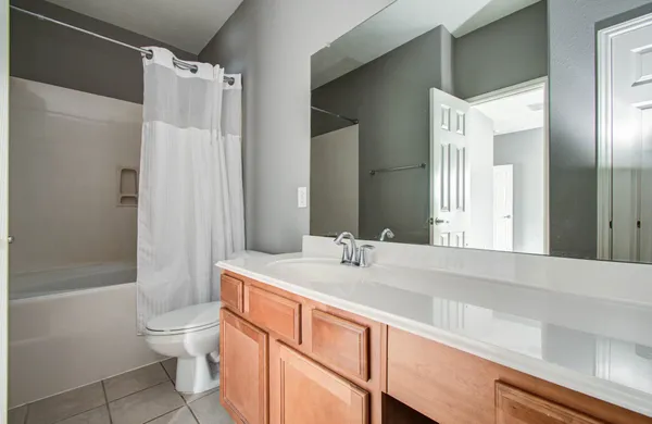 a bathroom with a sink toilet double vanity and shower