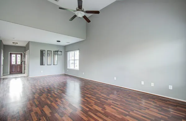 wooden floor in an empty room with a window