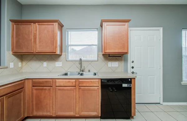 a kitchen with stainless steel appliances granite countertop wooden cabinets a sink and dishwasher