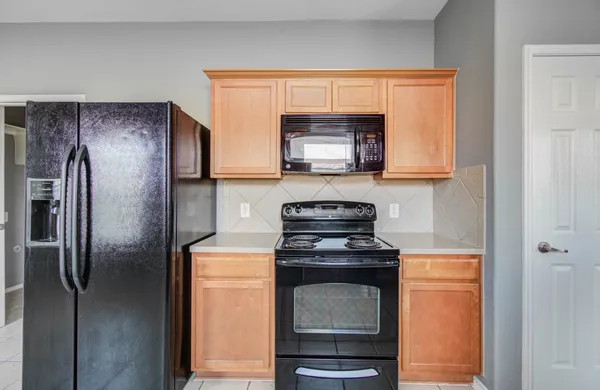 a kitchen with a refrigerator stove and microwave