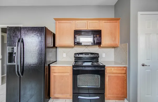 a kitchen with a refrigerator stove and microwave