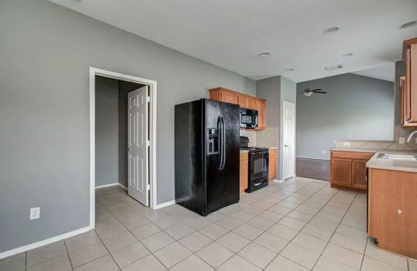 a view of kitchen with refrigerator and window
