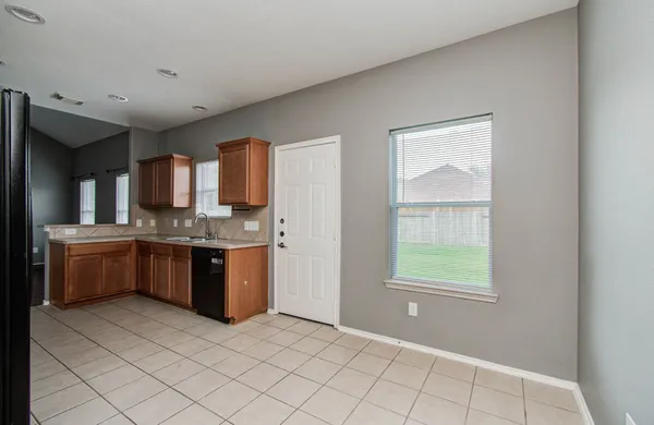 a large kitchen with a stove a sink dishwasher and a refrigerator