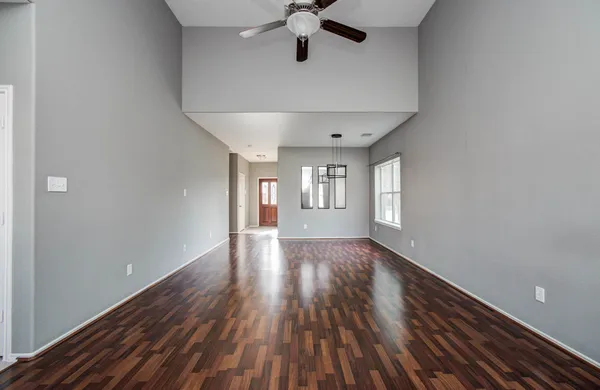 a view of wooden floor and windows in a room