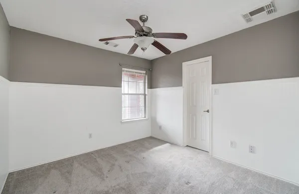 a view of room with window and ceiling fan