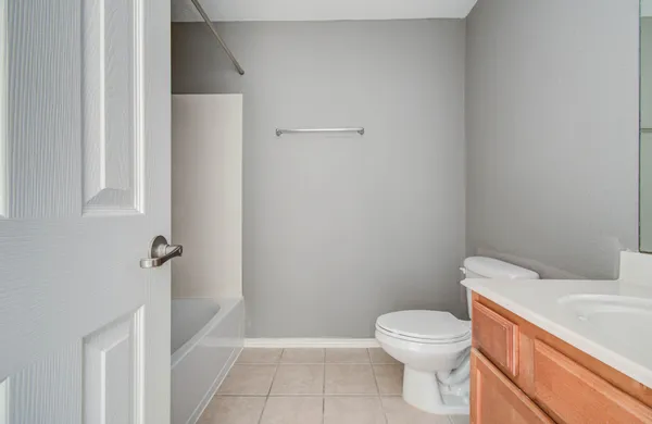 a white toilet sitting next to a bathroom sink