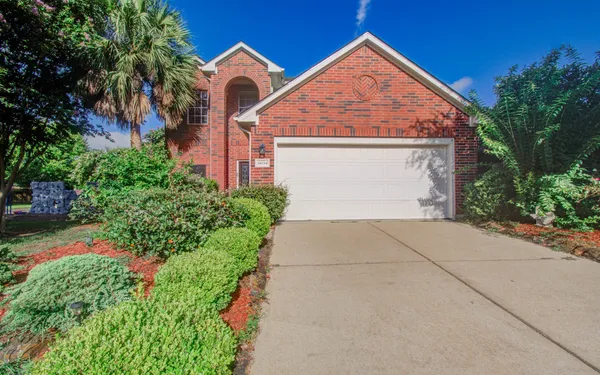 a view of backyard of house with green space