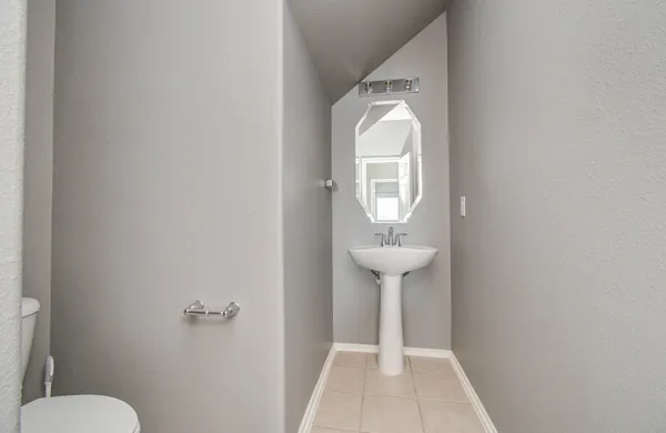 a view of bathroom with a sink toilet and a mirror