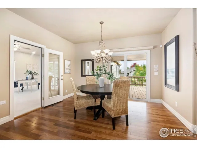 a dining room with furniture a chandelier and wooden floor