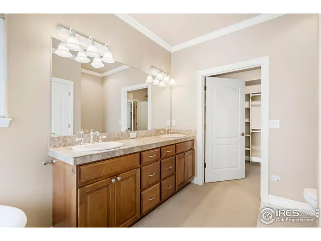 a bathroom with a granite countertop sink a large mirror and a shower