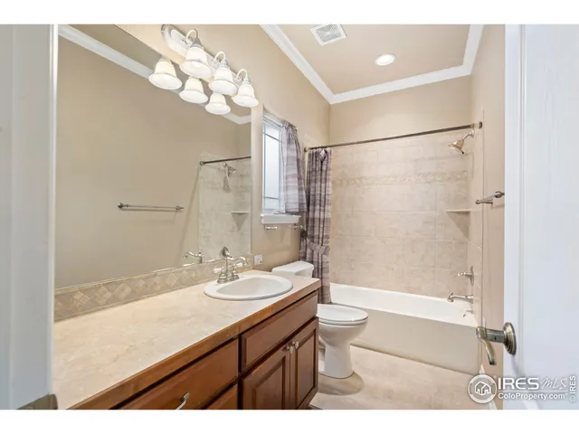 a bathroom with a sink a toilet a shower and a mirror