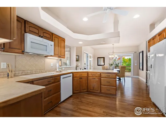 a kitchen with a sink dishwasher stove and wooden cabinets