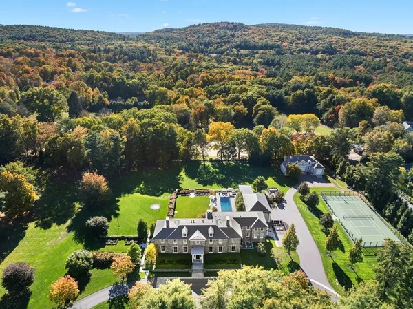 an aerial view of a house with a yard
