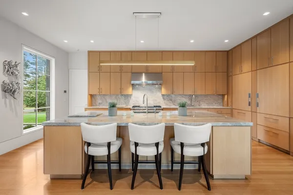 a kitchen with a dining table chairs and window