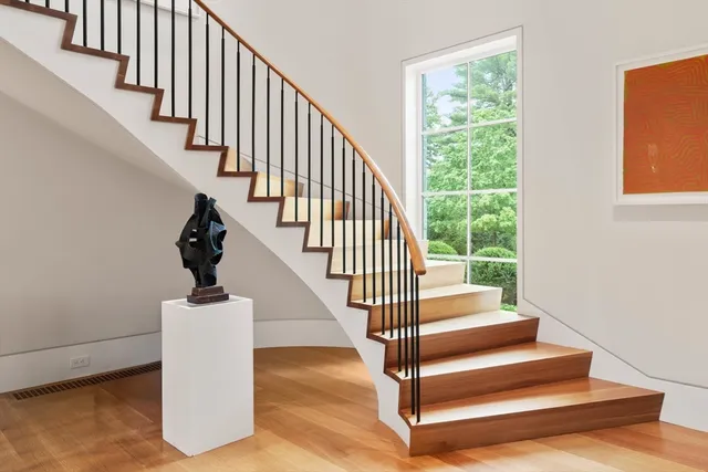 a view of entryway with wooden floor and a front door