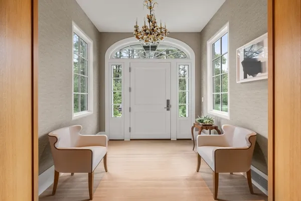 a view of a room with furniture and wooden floor