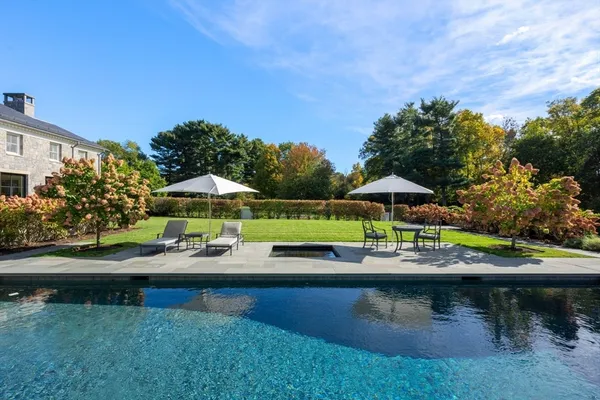 swimming pool view with a seating space