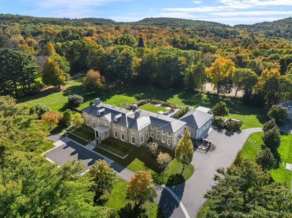 an aerial view of a house with a big yard
