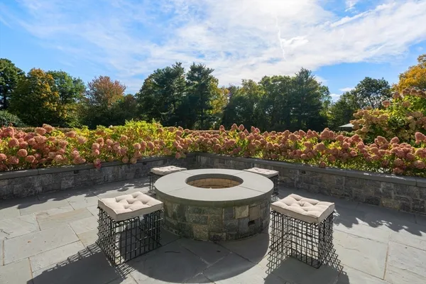 a view of a tennis ground with large trees