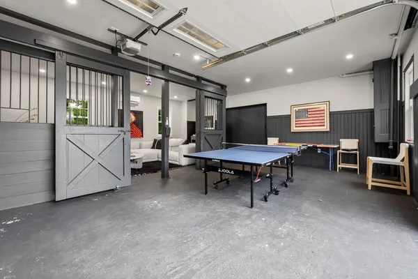 a living room with furniture a rug and a flat screen tv