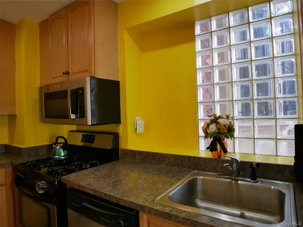a kitchen with a sink and a stove top oven