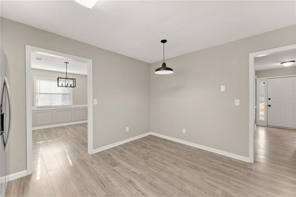 604 Fox Run Winder, GA 30680 - Photo 18 of 38 an empty room with wooden floor and window