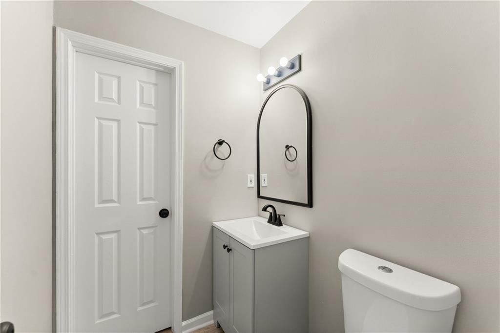 604 Fox Run Winder, GA 30680 - Photo 19 of 38 a bathroom with a toilet a sink and mirror