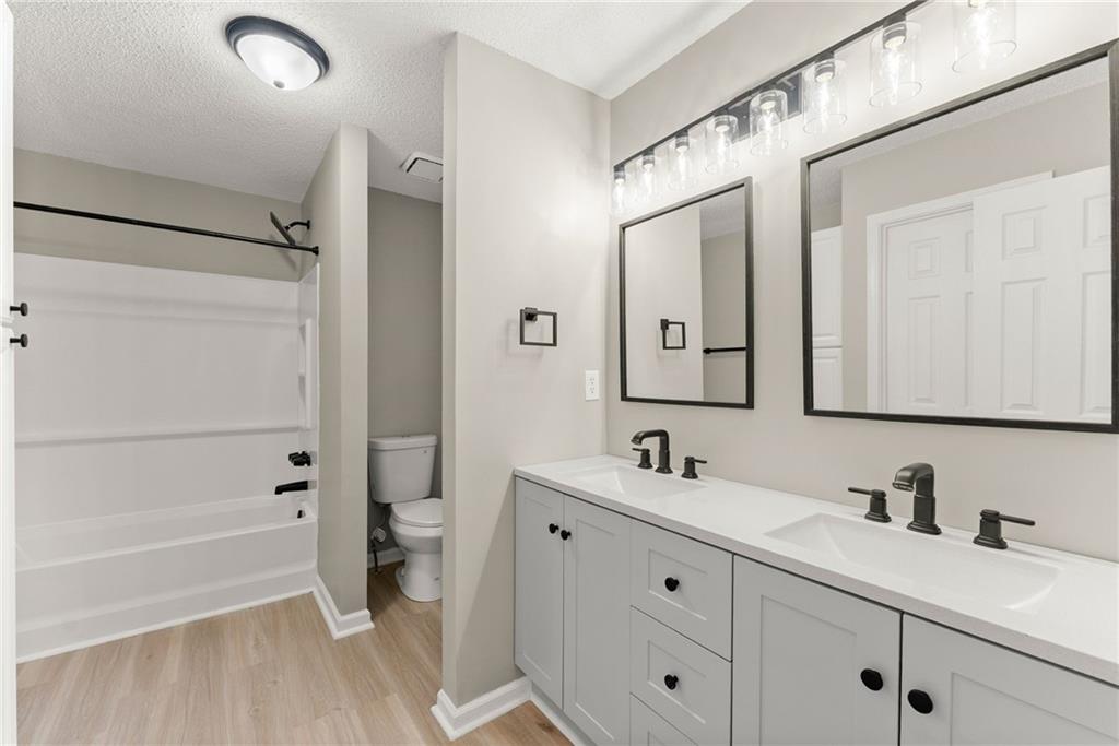 604 Fox Run Winder, GA 30680 - Photo 29 of 38 a bathroom with a double vanity sink a toilet and a tub