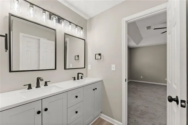 a bathroom with a double vanity sink and mirror
