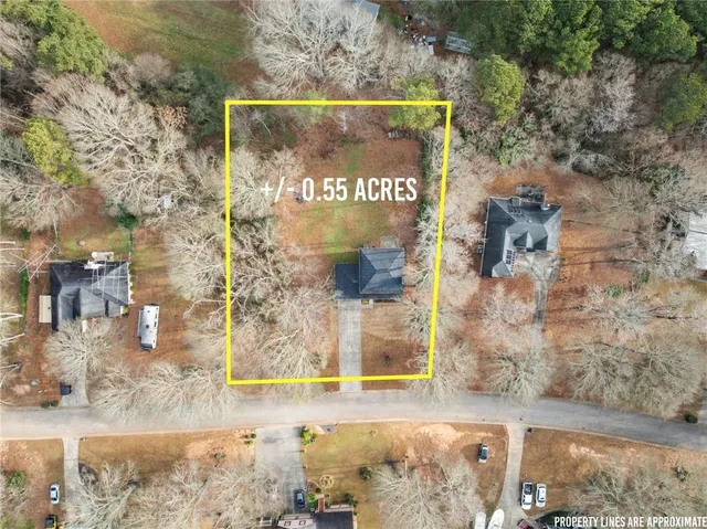 a view of a brick wall with building in the background