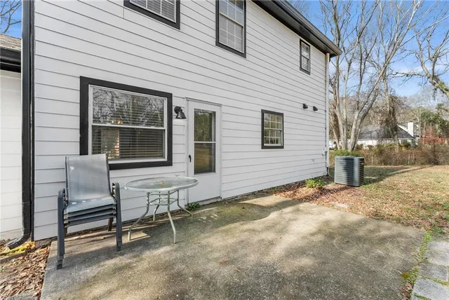 a view of a house with backyard and sitting area