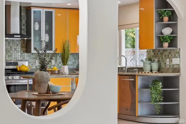 a dining table with chairs and a potted plant