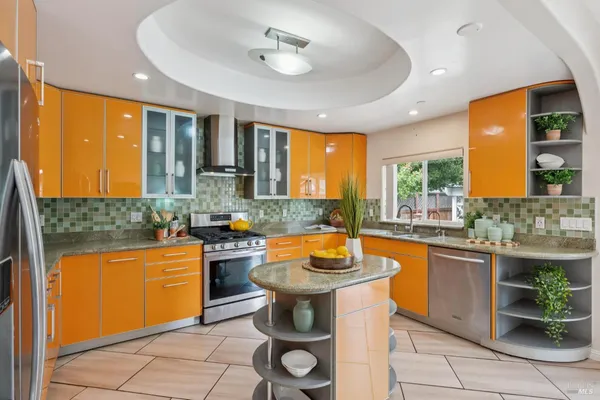 a kitchen with a sink a stove and a window