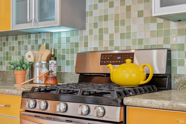 a stove top oven sitting inside of a kitchen
