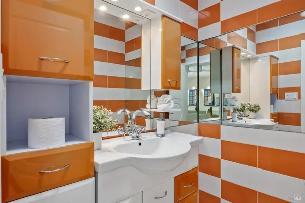 a bathroom with a sink and a large mirror