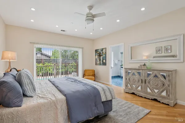 a spacious bedroom with a large bed and a window